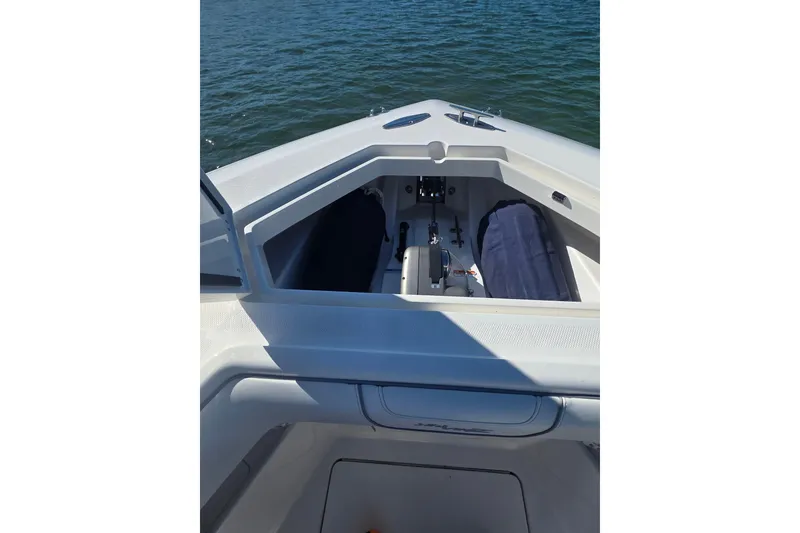 Slide: The Image of 2024 SeaVee 420Z boat interior with open storage compartment on calm water. - 9