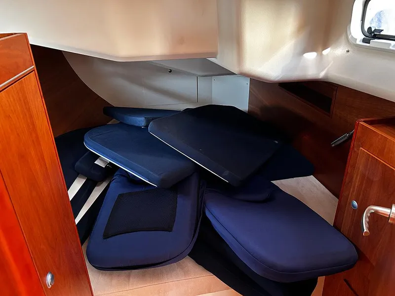 Slide: The Image of Interior of a 2016 Hanse 455 sailboat with blue cushions. - 14