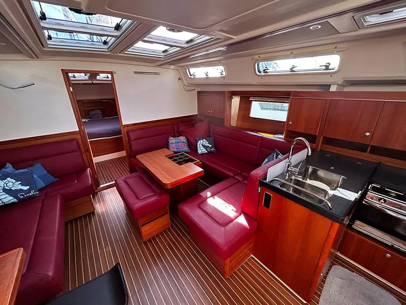 Slide: The Image of Interior of a 2016 Hanse 455 yacht with red leather and wood finish. - 16