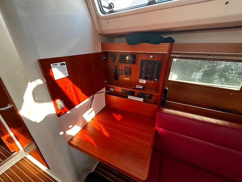 Slide: The Image of Interior of 2016 Hanse 455 yacht with wooden table and controls. - 22