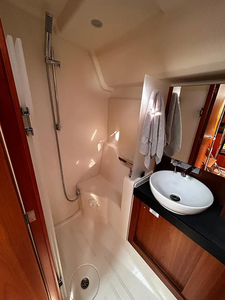 Slide: The Image of Hanse 455 yacht bathroom, 2016 model, featuring shower and sink. - 25