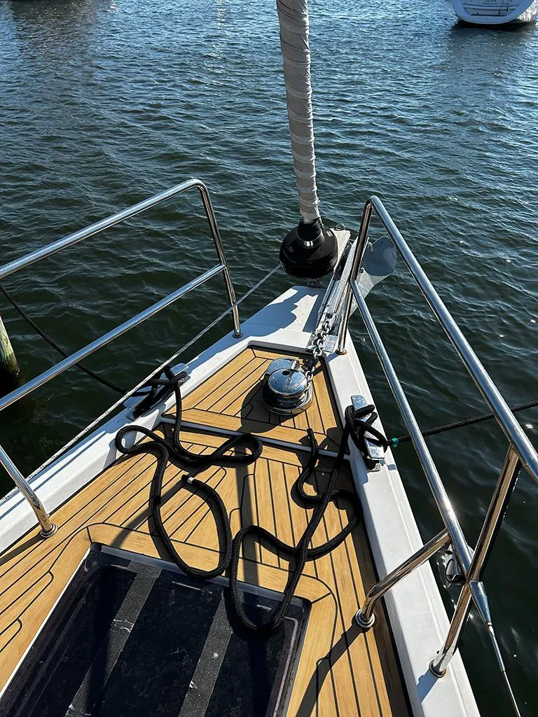 Slide: The Image of Deck of a 2016 Hanse 455 sailboat by the water. - 3