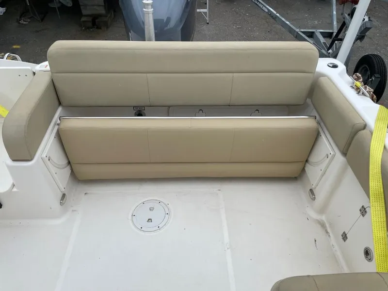 Slide: The Image of 2016 Pursuit DC 235 Dual Console boat with beige seating and white deck. - 10
