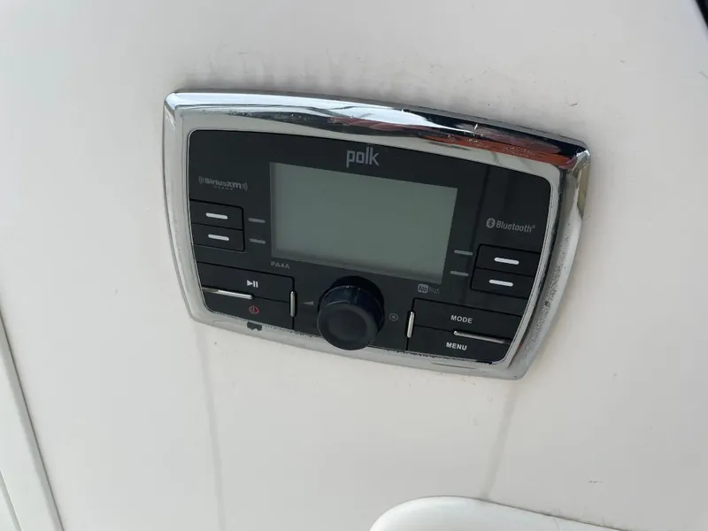 Slide: The Image of Polk audio system on 2016 Pursuit DC 235 Dual Console boat dashboard. - 14