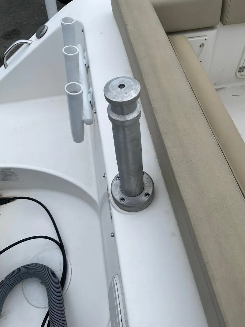 Slide: The Image of 2016 Pursuit DC 235 Dual Console boat interior with rod holders and seating. - 17