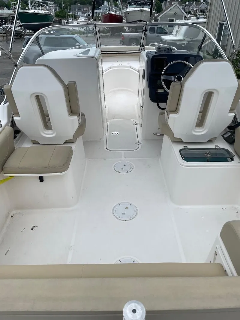 Slide: The Image of 2016 Pursuit DC 235 Dual Console boat interior with seating and steering wheel. - 5