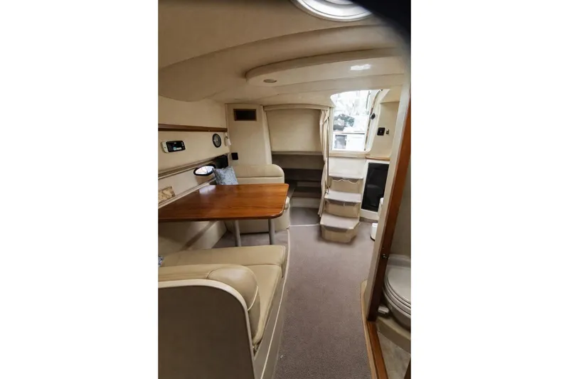 Slide: The Image of 2004 Cruisers Yachts 3372 Express cabin interior with dining area and stairs. - 8