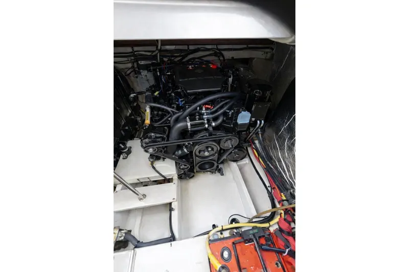 Slide: The Image of Engine compartment of 2004 Cruisers Yachts 3372 Express, showcasing mechanical components and wiring. - 9