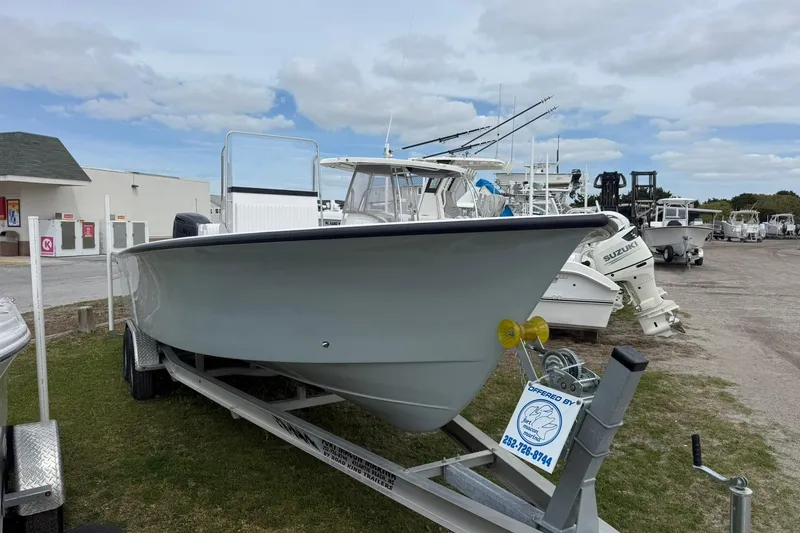The Image of 2026 C-Hawk 25 Center Console boat on trailer, displayed outdoors. - 0
