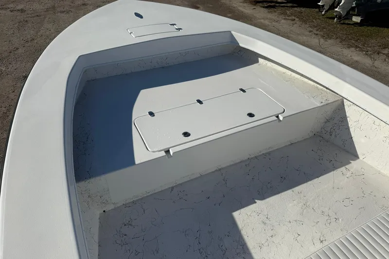 Slide: The Image of 2026 C-Hawk 25 Center Console boat interior with white seating and steering wheel. - 11