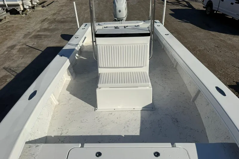 Slide: The Image of 2026 C-Hawk 25 Center Console boat interior with white seating and storage compartment. - 12