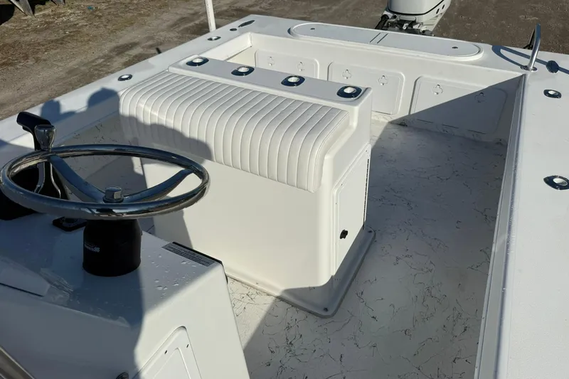 Slide: The Image of 2026 C-Hawk 25 Center Console boat with ladder and outboard motor, docked outdoors. - 13