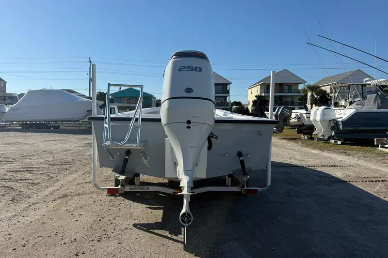 Slide: The Image of 2026 C-Hawk 25 Center Console boat with steering wheel and seating, docked outdoors. - 5