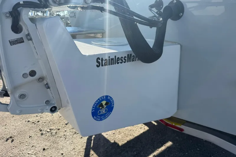 Slide: The Image of 2026 C-Hawk 25 Center Console boat on trailer, parked near trucks and other boats. - 7