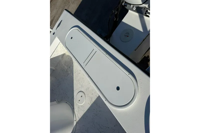 Slide: The Image of 2026 C-Hawk 25 Center Console boat with Suzuki engine on trailer, parked outdoors. - 9