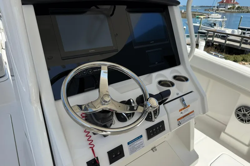 Slide: The Image of Steering console of 2026 World Cat 280 CC-X boat with modern controls and displays. - 15