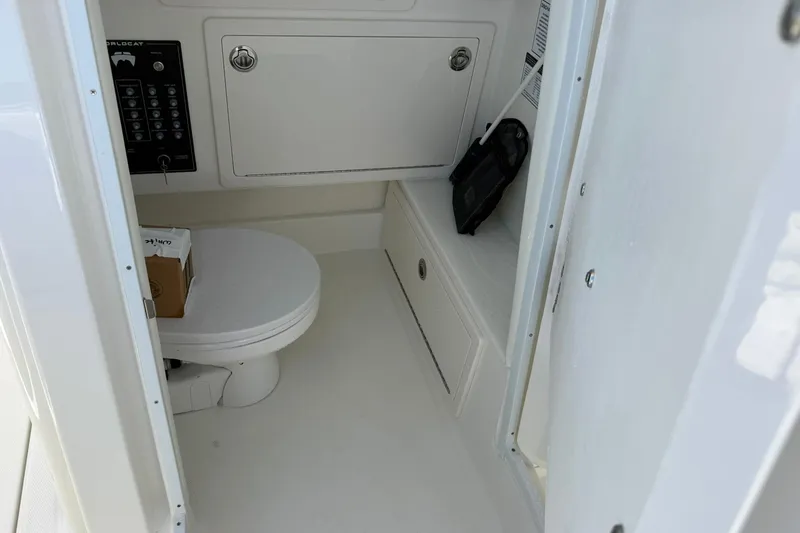 Slide: The Image of Interior of 2026 World Cat 280 CC-X boat featuring a compact marine toilet. - 21