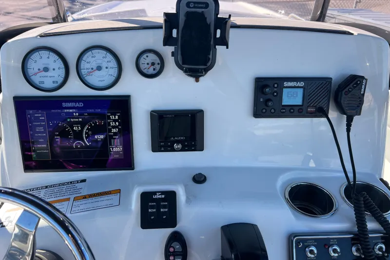Slide: The Image of 2021 NauticStar 231 Hybrid boat dashboard with Simrad electronics and JL Audio system. - 10