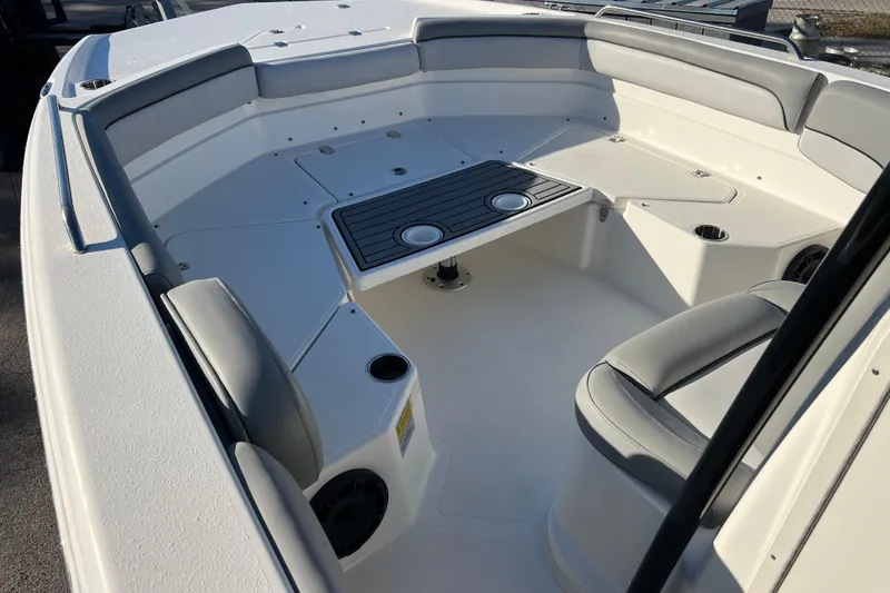 Slide: The Image of 2021 NauticStar 231 Hybrid boat interior with seating and cup holders. - 11
