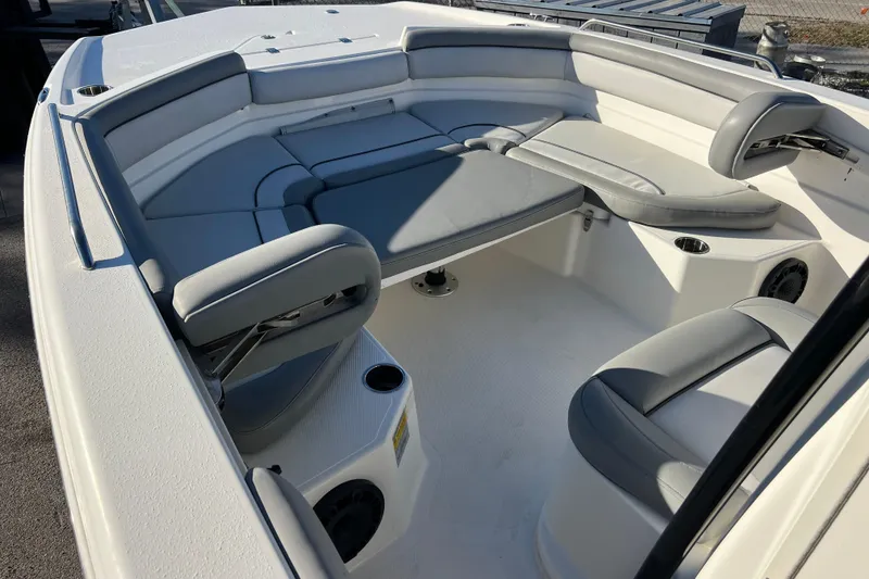Slide: The Image of 2021 NauticStar 231 Hybrid boat interior with cushioned seating and cup holders. - 12