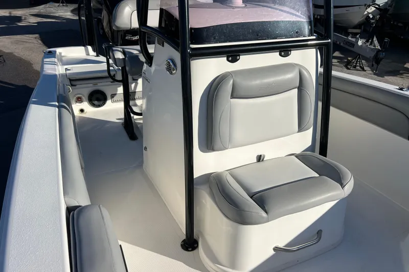 Slide: The Image of 2021 NauticStar 231 Hybrid boat interior with cushioned seating and console. - 15