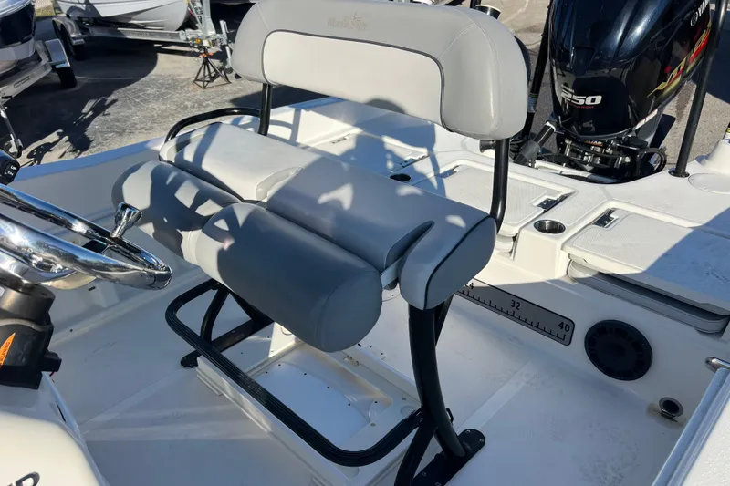 Slide: The Image of 2021 NauticStar 231 Hybrid boat interior with steering wheel and seating. - 16