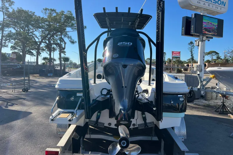 Slide: The Image of 2021 NauticStar 231 Hybrid boat with powerful outboard motor in a marina setting. - 4