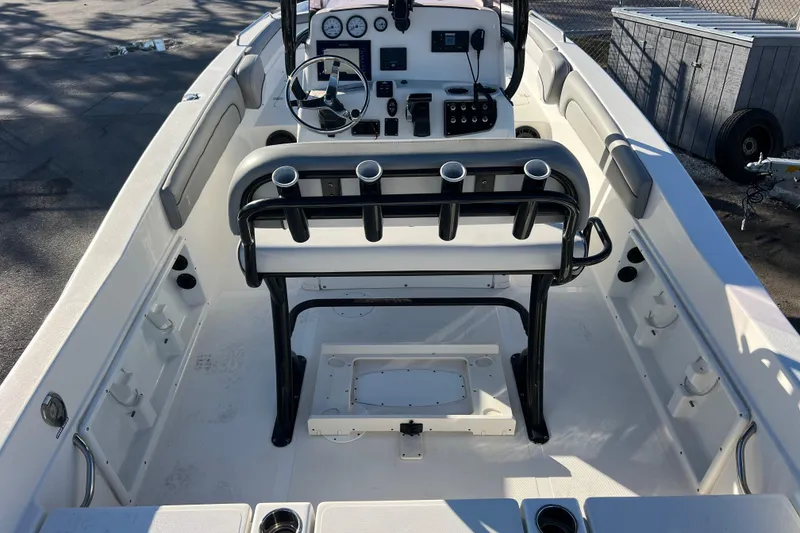 Slide: The Image of 2021 NauticStar 231 Hybrid boat interior with steering console and rod holders. - 7