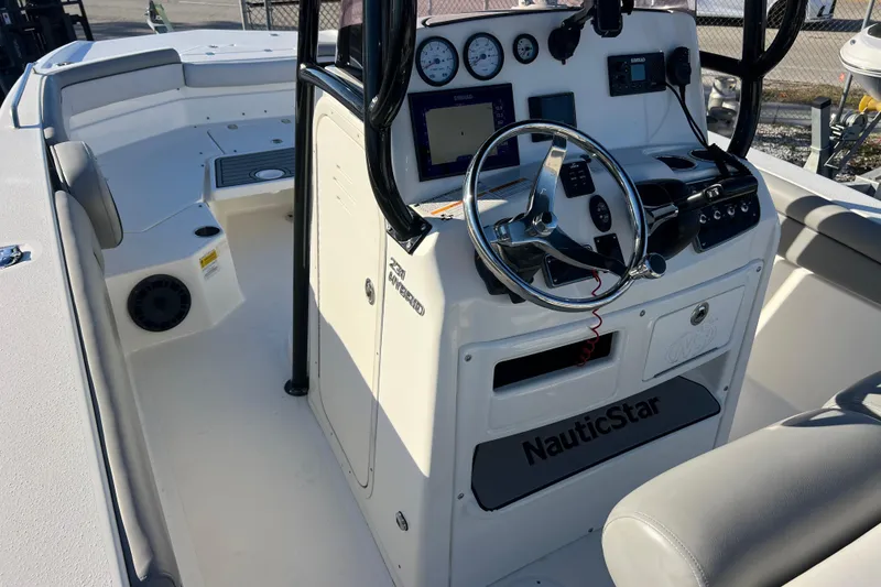 Slide: The Image of 2021 NauticStar 231 Hybrid boat interior with steering console and seating area. - 8