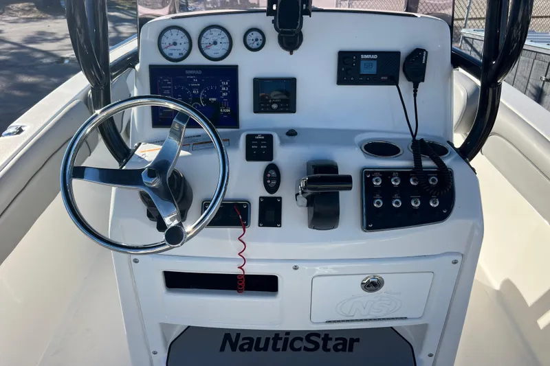 Slide: The Image of 2021 NauticStar 231 Hybrid boat console with steering wheel and navigation controls. - 9