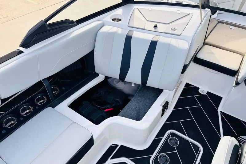 Slide: The Image of 2024 Malibu Wakesetter 22 LSV interior with open storage compartment and sleek seating. - 17