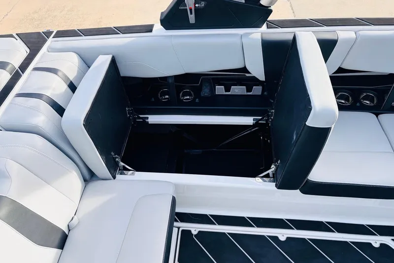 Slide: The Image of 2024 Malibu Wakesetter 22 LSV interior seating with open storage compartments. - 21
