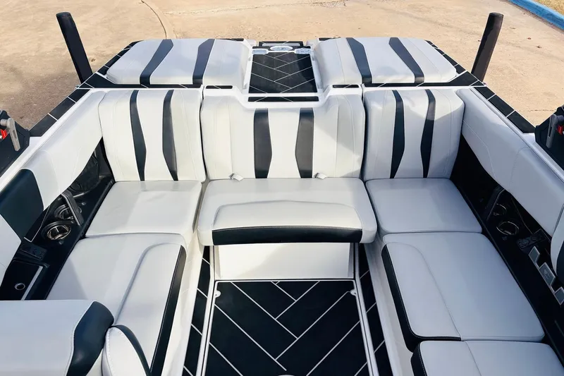 Slide: The Image of 2024 Malibu Wakesetter 22 LSV interior with sleek black and white seating design. - 22