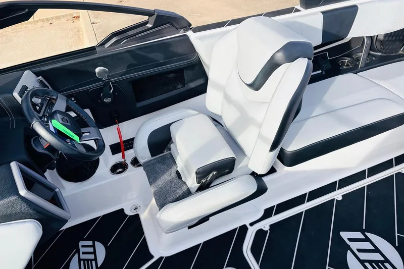 Slide: The Image of 2024 Malibu Wakesetter 22 LSV interior with sleek black and white seating and modern dashboard. - 29