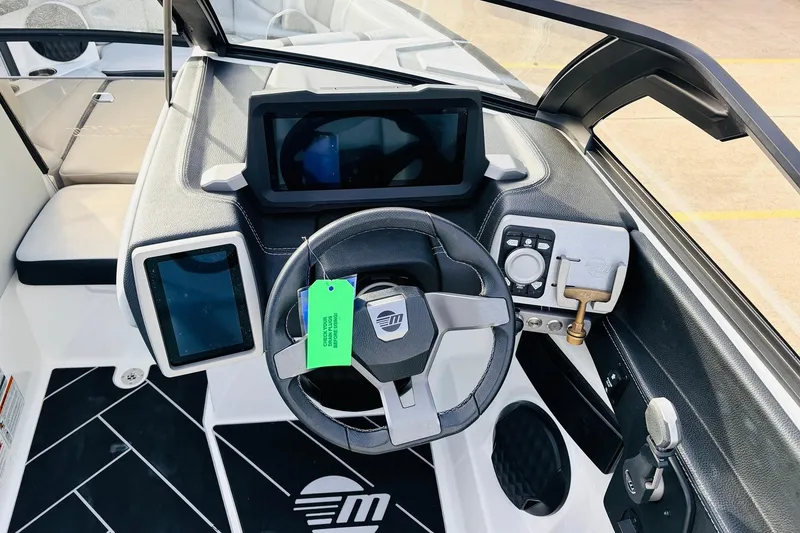 Slide: The Image of 2024 Malibu Wakesetter 22 LSV dashboard with modern controls and steering wheel. - 30