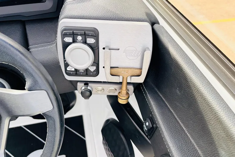 Slide: The Image of 2024 Malibu Wakesetter 22 LSV dashboard controls with steering wheel detail. - 33