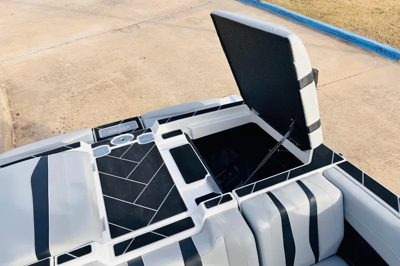 Slide: The Image of 2024 Malibu Wakesetter 22 LSV boat interior with open storage compartment. - 34