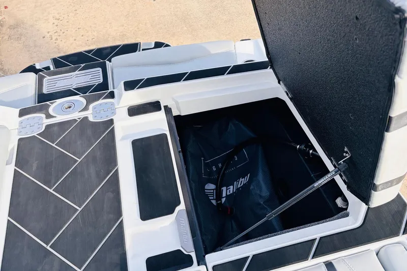 Slide: The Image of 2024 Malibu Wakesetter 22 LSV storage compartment with open hatch and sleek design. - 35