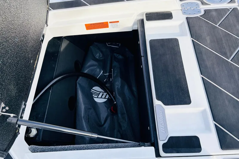 Slide: The Image of 2024 Malibu Wakesetter 22 LSV storage compartment with ballast bag and hydraulic support. - 37
