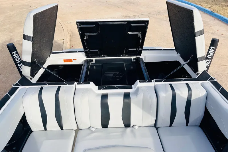Slide: The Image of 2024 Malibu Wakesetter 22 LSV interior with open storage compartments and stylish seating. - 38
