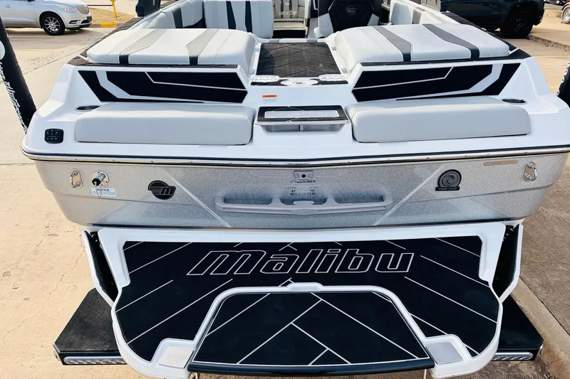 Slide: The Image of 2024 Malibu Wakesetter 22 LSV boat, rear view with sleek design and branding. - 44