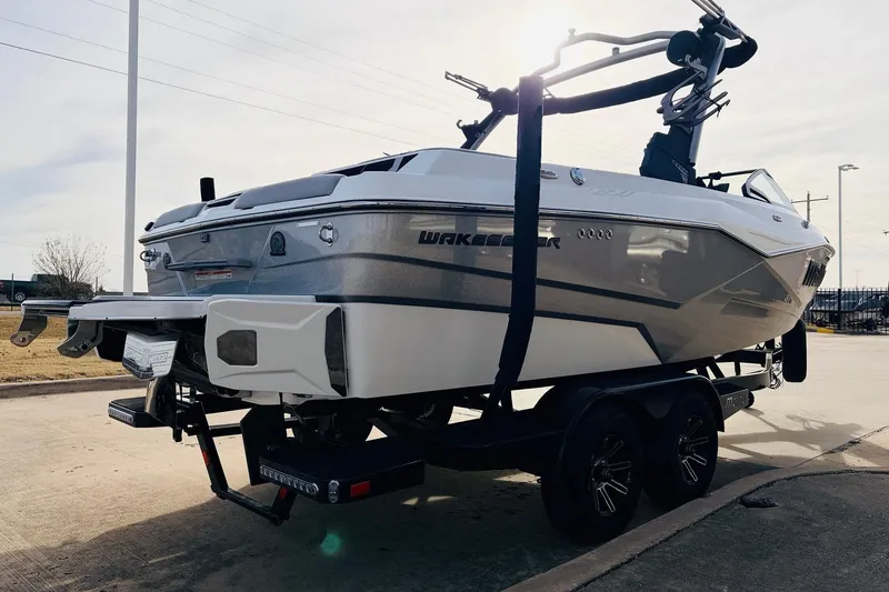 Slide: The Image of 2024 Malibu Wakesetter 22 LSV boat on trailer, parked outdoors. - 5