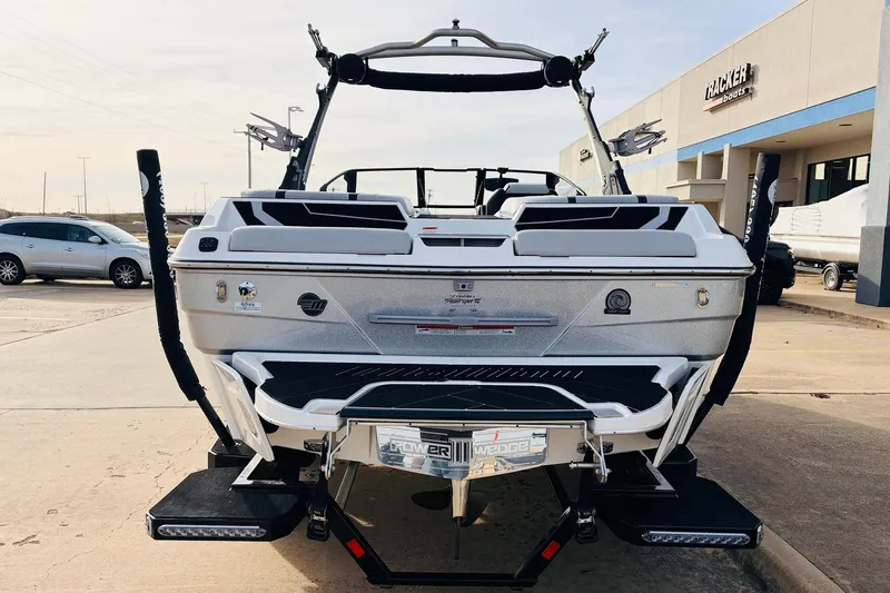 Slide: The Image of 2024 Malibu Wakesetter 22 LSV boat, rear view at dealership, showcasing sleek design. - 6