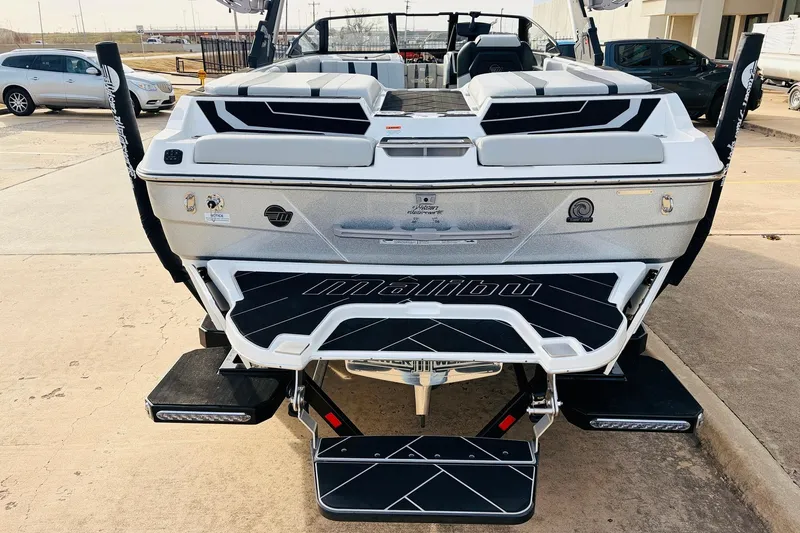 Slide: The Image of 2024 Malibu Wakesetter 22 LSV boat rear view, showcasing sleek design and branding. - 9