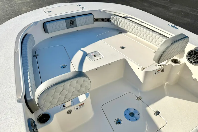 Slide: The Image of 2026 Carolina Skiff 26 Ultra Elite boat interior with cushioned seating and storage compartments. - 15