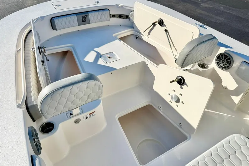 Slide: The Image of 2026 Carolina Skiff 26 Ultra Elite boat interior with seating and storage compartments. - 16