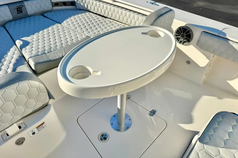 Slide: The Image of 2026 Carolina Skiff 26 Ultra Elite boat interior with seating and table. - 22