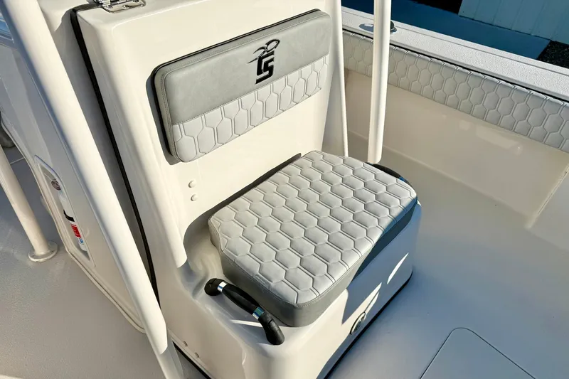 Slide: The Image of 2026 Carolina Skiff 26 Ultra Elite boat seat with hexagonal pattern and logo. - 25