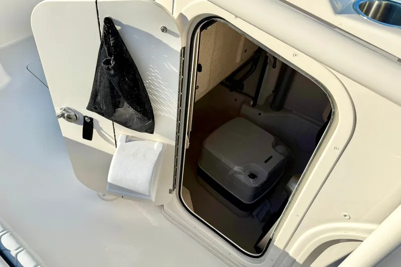 Slide: The Image of 2026 Carolina Skiff 26 Ultra Elite boat interior with open storage compartment. - 28