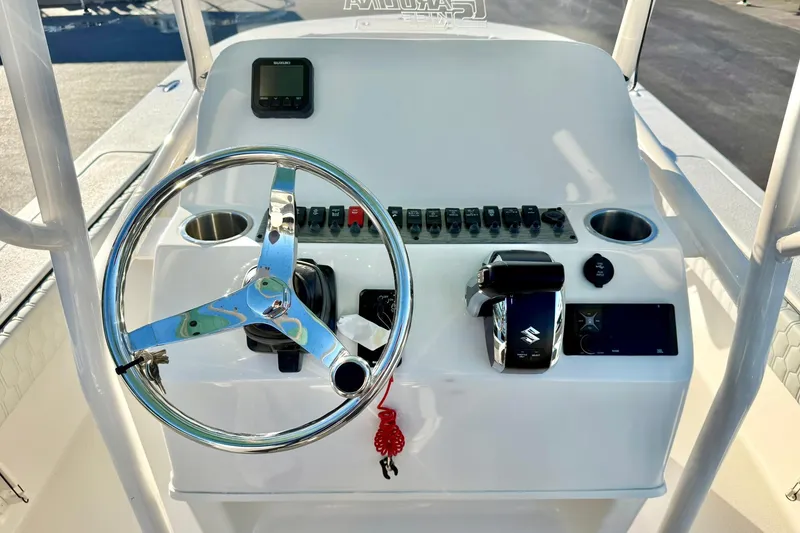 Slide: The Image of 2026 Carolina Skiff 26 Ultra Elite boat console with steering wheel and controls. - 3